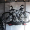 Crookstopper wall mounted hitch lock security post used as bike carrier storage.